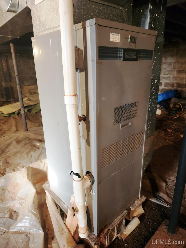 utility room featuring heating unit