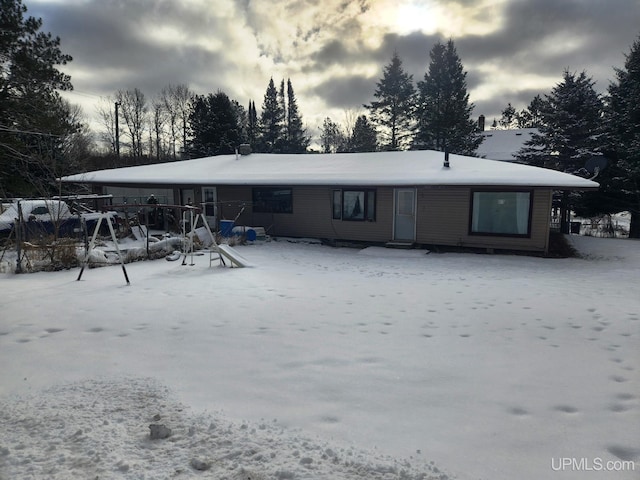 view of snow covered back of property