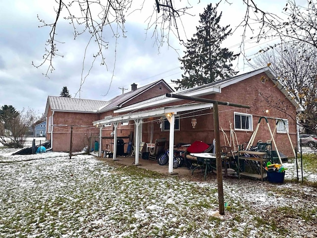 view of snow covered rear of property