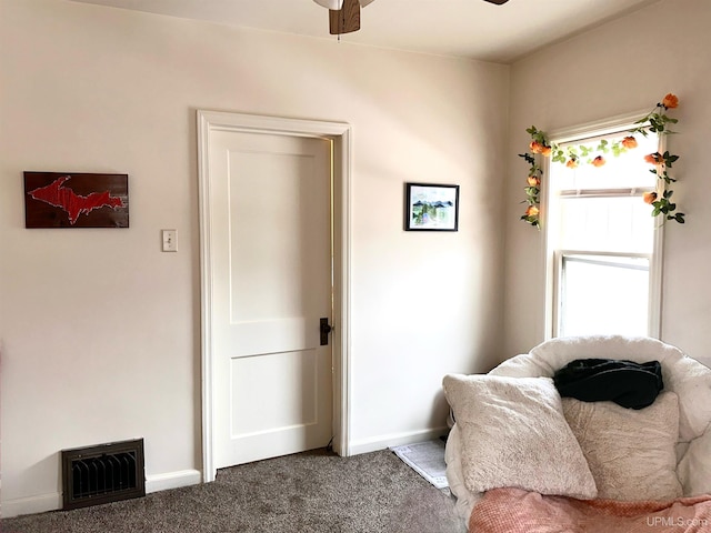 sitting room with ceiling fan and carpet floors