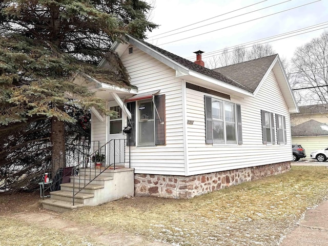 view of side of property with a lawn