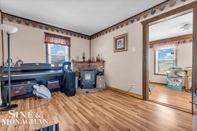 misc room with a wood stove and wood-type flooring