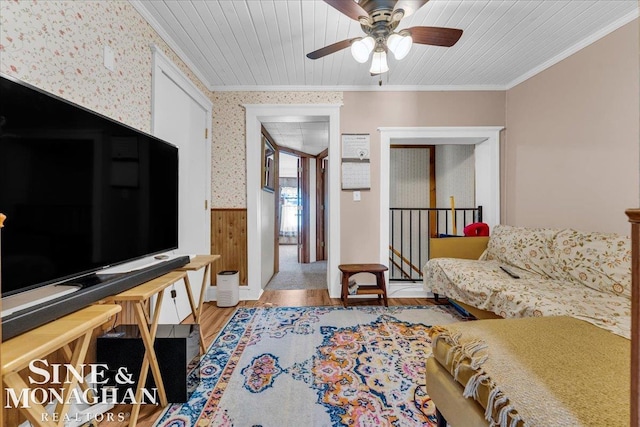 living room featuring light wood-type flooring, wooden ceiling, ceiling fan, and ornamental molding