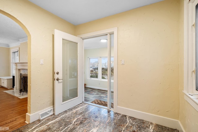 doorway to outside featuring hardwood / wood-style floors and crown molding