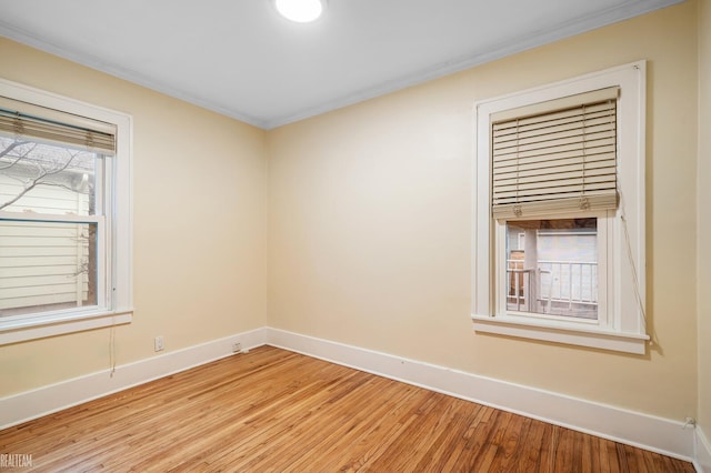 unfurnished room with crown molding and light hardwood / wood-style floors