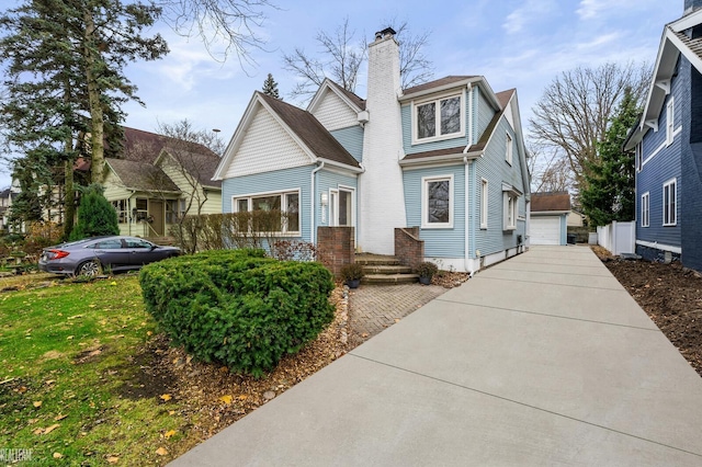 view of front of home featuring a garage and an outdoor structure