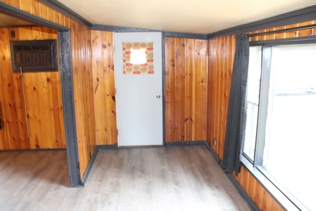 unfurnished room featuring ornamental molding, dark hardwood / wood-style flooring, and wooden walls