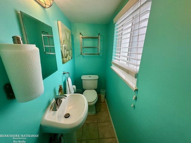 bathroom featuring tile patterned floors, toilet, and sink