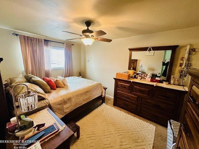 bedroom featuring ceiling fan and light colored carpet