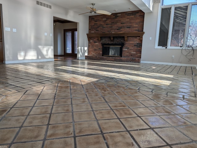 unfurnished living room with ceiling fan and a fireplace