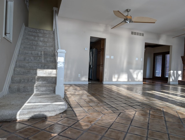 interior space with ceiling fan