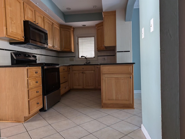 kitchen with light brown cabinets, sink, range with electric cooktop, tasteful backsplash, and light tile patterned flooring