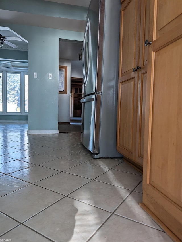 kitchen with stainless steel fridge, ceiling fan, and light tile patterned flooring