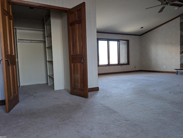 unfurnished bedroom with ceiling fan, crown molding, light carpet, and a closet