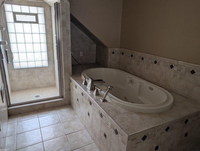 bathroom featuring tile patterned flooring, vaulted ceiling, and independent shower and bath