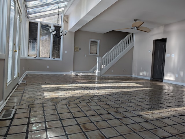 unfurnished living room with ceiling fan