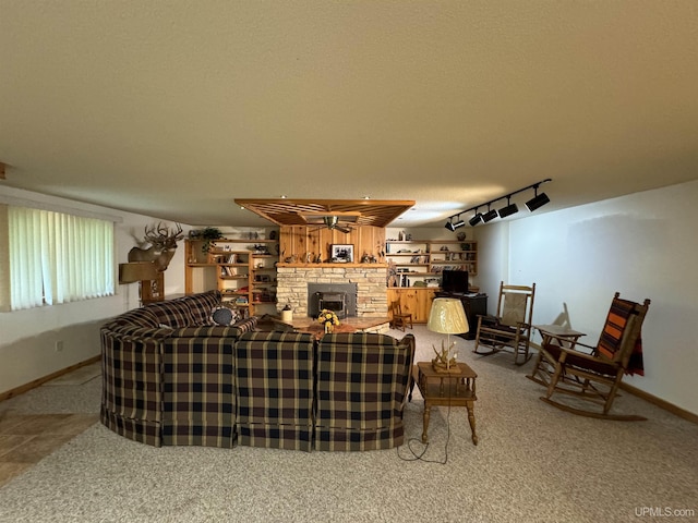 living room featuring a textured ceiling, carpet floors, and track lighting