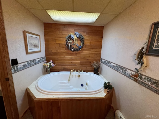 bathroom with a washtub, a paneled ceiling, and baseboard heating