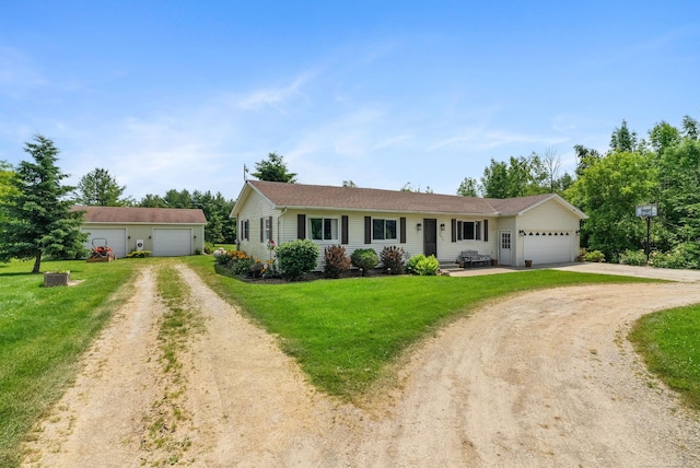 ranch-style home with a garage, an outdoor structure, and a front yard