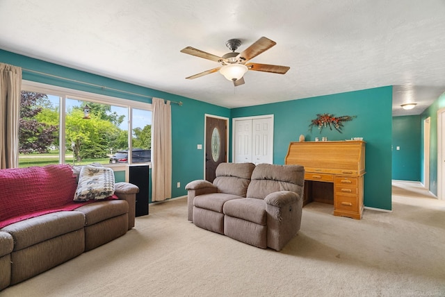 carpeted living room featuring ceiling fan