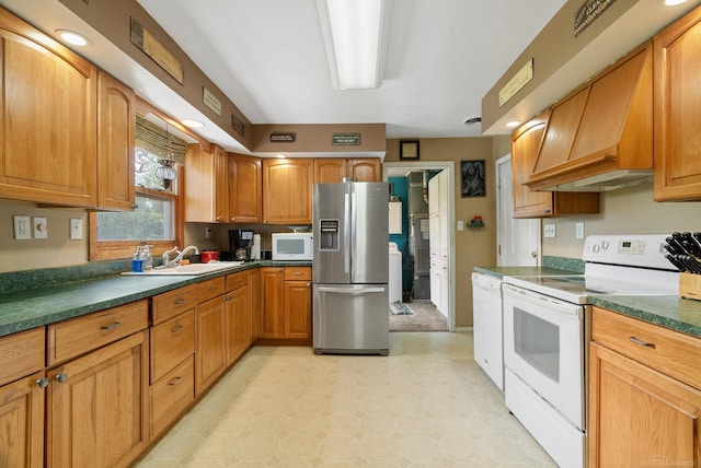 kitchen with white appliances, sink, and premium range hood