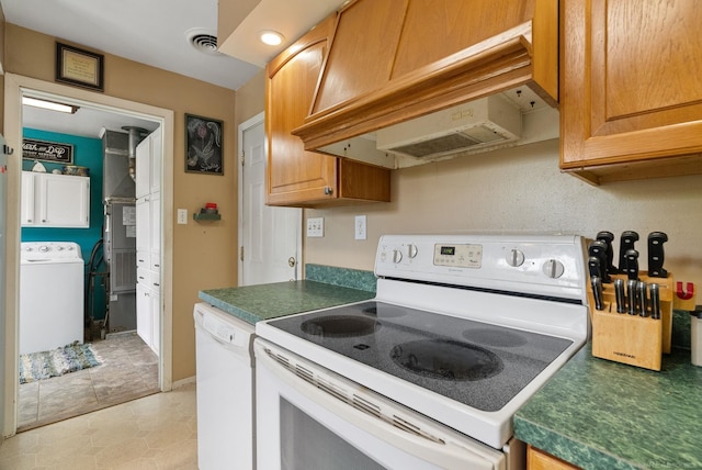 kitchen with light tile patterned flooring, white appliances, washer / clothes dryer, and custom exhaust hood