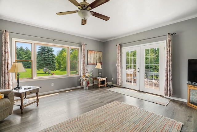 living area with french doors, dark hardwood / wood-style floors, ceiling fan, and crown molding