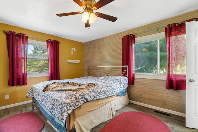 bedroom with light hardwood / wood-style floors and ceiling fan