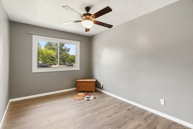 empty room featuring light hardwood / wood-style flooring and ceiling fan