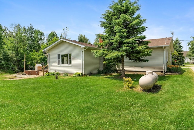 rear view of property featuring a lawn