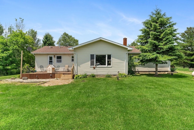 back of property featuring a lawn and a wooden deck