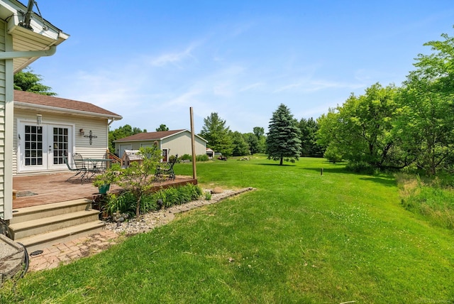 view of yard featuring a deck and french doors