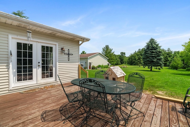 deck featuring a yard and french doors