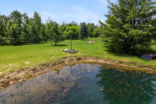 view of property's community with a yard and a water view