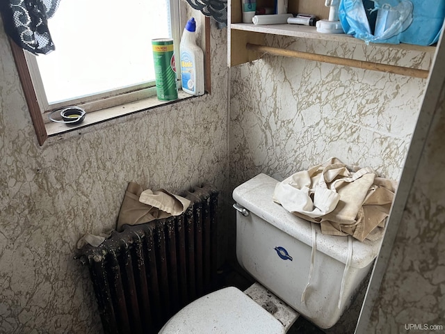 bathroom featuring radiator and toilet