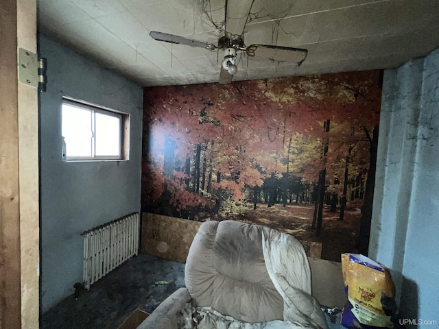 sitting room featuring ceiling fan and radiator