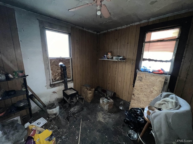 misc room with wood walls and ceiling fan