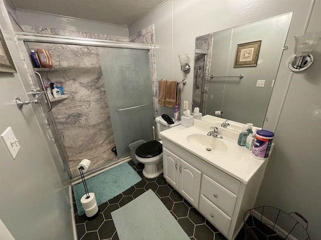 bathroom featuring vanity, a textured ceiling, a shower with door, tile patterned flooring, and toilet