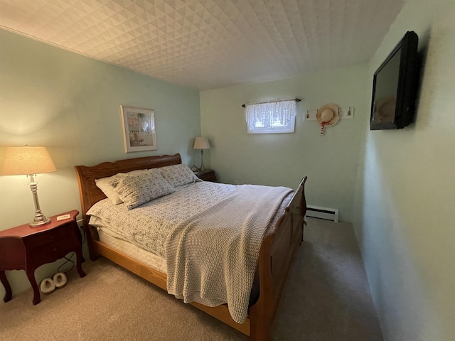 bedroom featuring carpet floors and a baseboard heating unit