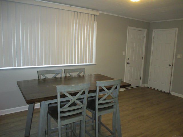 unfurnished dining area with dark wood-type flooring and crown molding