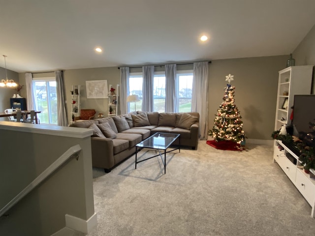 living room with carpet and a chandelier