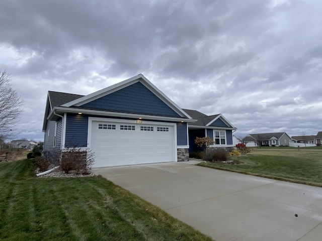 view of front of house with a front yard and a garage