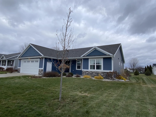 view of front of property featuring a garage and a front lawn