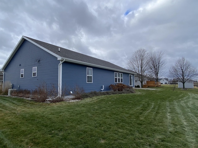 view of home's exterior with a lawn and cooling unit