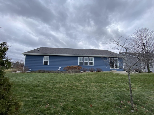 rear view of property featuring a yard