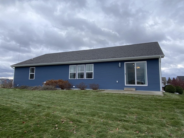 rear view of house featuring a lawn