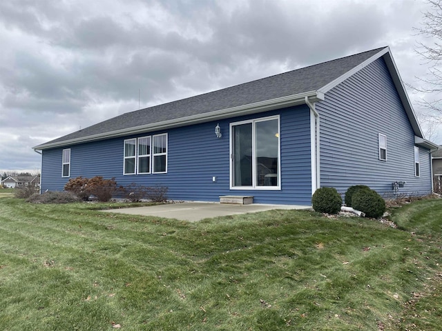 back of property with a patio and a lawn