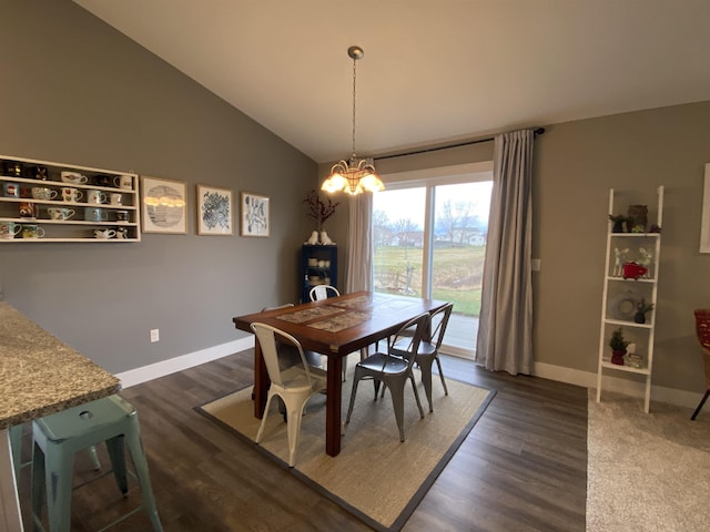 dining room featuring dark hardwood / wood-style flooring, vaulted ceiling, and a notable chandelier