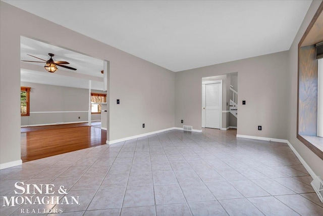 empty room featuring ceiling fan and light tile patterned floors