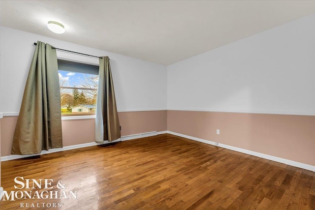 unfurnished room with hardwood / wood-style flooring